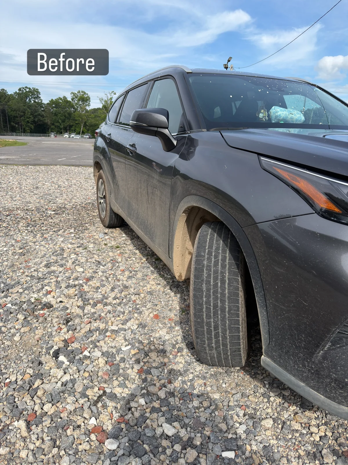 Grey Toyota Highlander covered in road dust and dirt film before detailing